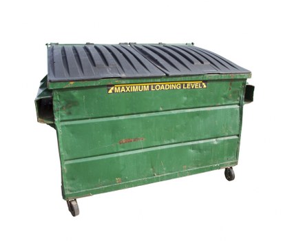 A large, green metal waste skip with a reinforced ribbed black plastic lid, situated on a paved surface, likely in an outdoor area such as a driveway or yard. The skip features four small caster wheels at the base for mobility and has a yellow label indicating the maximum loading level. The surface of the skip shows signs of wear, including minor rust spots and scratches, typical of a bin used for commercial waste collection. It is positioned with its front-facing side visible, and the lid is closed, with a slight gap on the sides. The background is plain white, emphasizing the detailed features of the waste container, which is indicative of commercial waste removal services, such as those offered by Commercial Waste Removal Wood Green, serving local areas around N22 postcode.