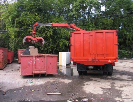 Company van and crew preparing to collect commercial waste at a business site